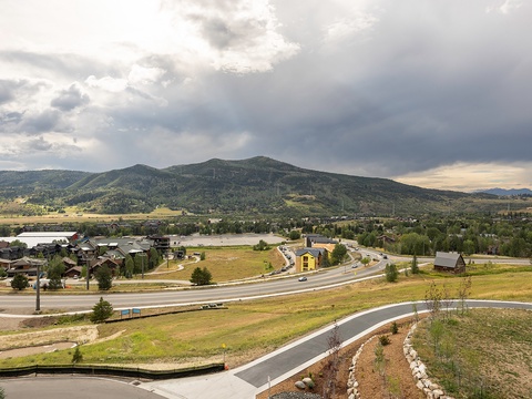 A scenic mountain community nestled beside a tranquil lake, surrounded by forested peaks and open skies. The property is located in this peaceful natural setting.