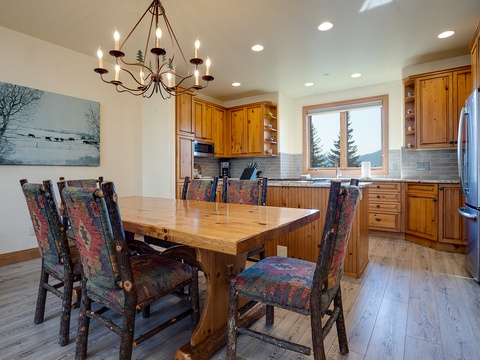 Gather around this warm, rustic dining table bathed in natural light—your perfect spot for sharing meals, stories, and making memories together in this inviting space.