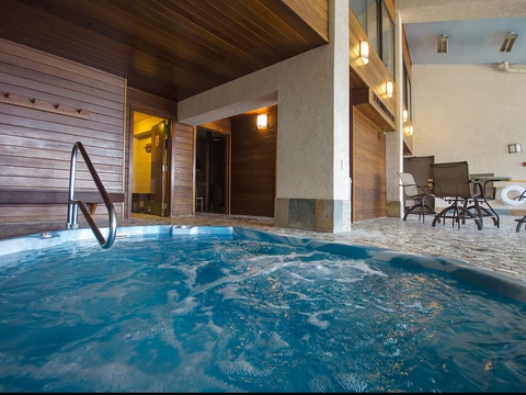 Slip into your private hot tub and let the warm, bubbling water melt away tension while you relax in this inviting spa-like setting.