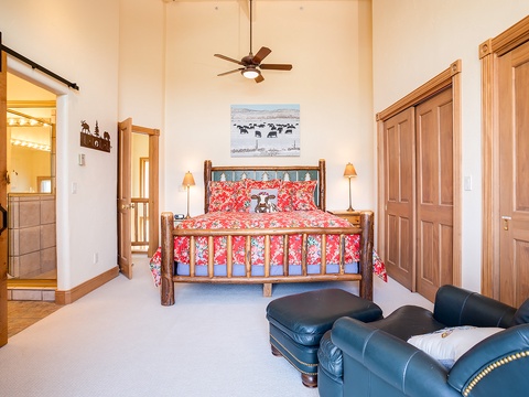 Unwind in your rustic-chic retreat with soaring ceilings, handcrafted log bed, and cozy leather seating—your peaceful mountain escape awaits.