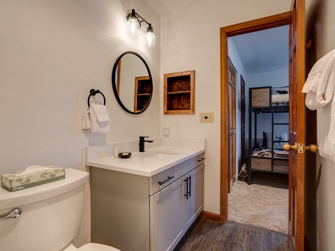 Step into your private bathroom with a crisp vanity, cozy lighting, and fresh towels awaiting your arrival—a peaceful retreat after a long day of exploring.
