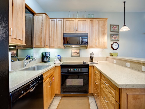 Your fully-equipped kitchen features warm maple cabinetry, modern appliances, and generous counter space—perfect for preparing your favorite meals during your stay.