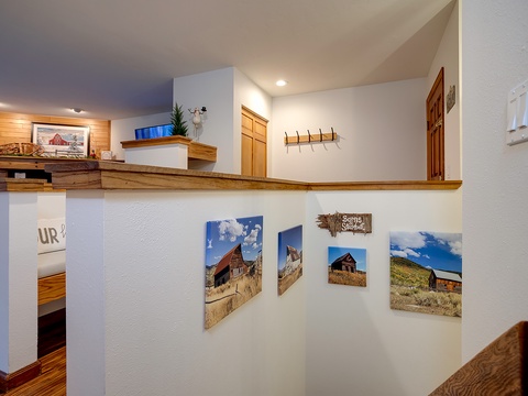 Your loft space features rustic barn-inspired artwork and warm wood accents, creating a cozy connection to the countryside charm throughout your home.