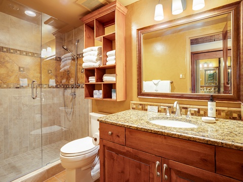 Step into your private spa-like retreat with elegant granite counters, rich wood cabinetry, and a luxurious walk-in shower stocked with fresh towels—perfect for unwinding after a day of adventure.