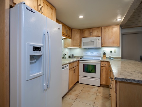 Your fully equipped kitchen features modern appliances, ample counter space, and warm wood cabinetry—everything you need to cook your favorite meals during your stay.