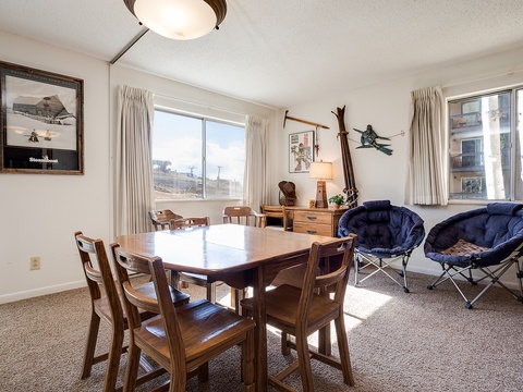 Relax in this sun-filled living and dining space, where your group can gather for meals, games, and conversations by the large windows overlooking the city.