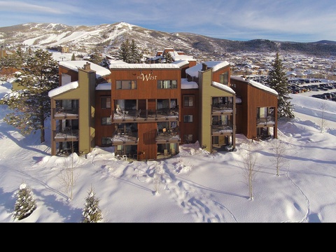 Aerial view of the property nestled in snow-covered mountain terrain, showcasing its prime location near winter recreation areas and scenic landscapes.
