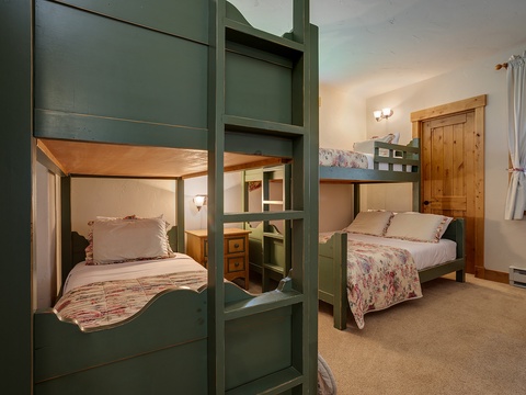 Your cozy retreat features charming bunk beds with soft linens and warm wood accents, creating a welcoming space where your whole family can rest comfortably together.