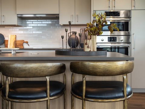 Picture yourself gathering at this sleek kitchen island, enjoying morning coffee or sharing stories over a home-cooked meal, all in this beautifully appointed, modern space.