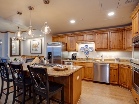 Picture yourself preparing meals in this spacious kitchen with granite countertops, stainless appliances, and a welcoming island perfect for gathering with loved ones over morning coffee or evening conversations.