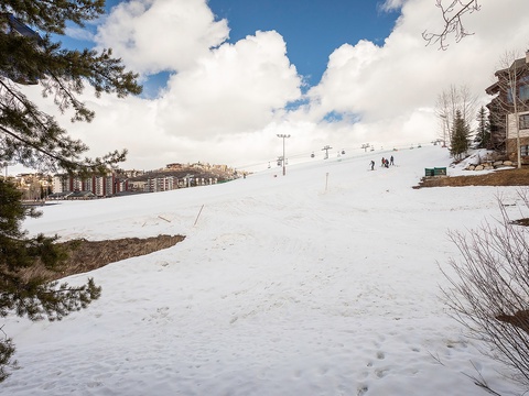 A ski-in/ski-out location with direct slope access, surrounded by resort lodges and alpine scenery. The property offers convenient proximity to chairlifts and mountain terrain.