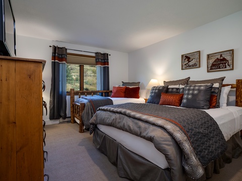 Drift off in your cozy retreat, where rustic charm meets mountain-lodge elegance. Two plush beds and peaceful views promise restful nights after your adventures.