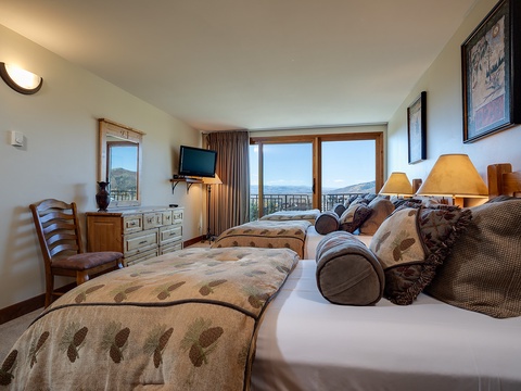 Wake up to mountain views from your cozy beds, where warm natural light fills the room and peaceful vistas stretch beyond your windows.