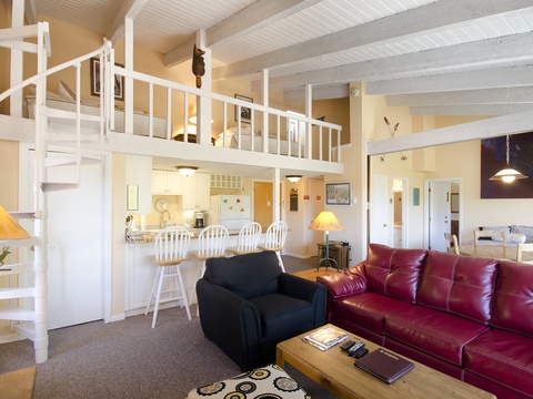Step into your spacious open-plan retreat with soaring ceilings, a cozy loft, and a full kitchen—your perfect home base for unforgettable getaways.