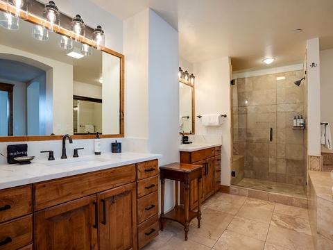 Unwind in your spacious ensuite bathroom with double vanities, generous counter space, and a luxurious walk-in shower with elegant tile work.