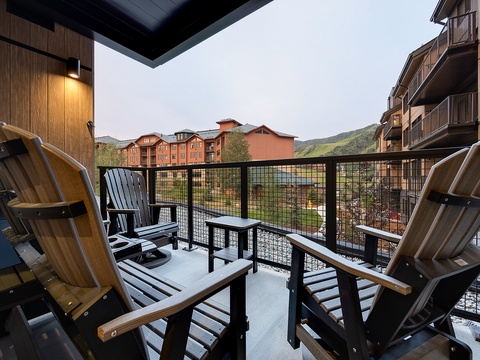 Settle into your private balcony with mountain views stretching toward rolling green hills. Perfect for morning coffee or evening relaxation in the fresh alpine air.