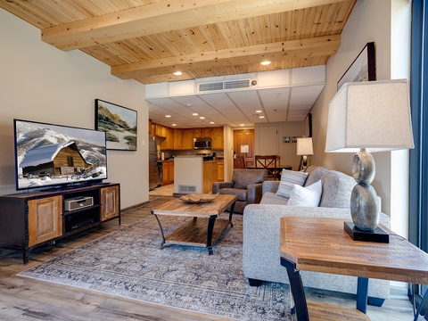 Settle in and make yourself at home in this open, light-filled space where modern comfort meets mountain charm beneath beautiful wood-beam ceilings.