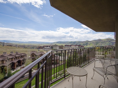 Expansive mountain views stretch across the horizon from this elevated balcony, offering a peaceful vantage point over rolling hills and distant peaks.