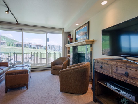 Unwind in your cozy living room with mountain views, a fireplace, and entertainment ready for your evenings in. Your perfect home base for relaxation.