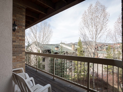 Sip your morning coffee on this covered balcony while taking in peaceful views of the surrounding neighborhood and mountain backdrop. A quiet spot to unwind.