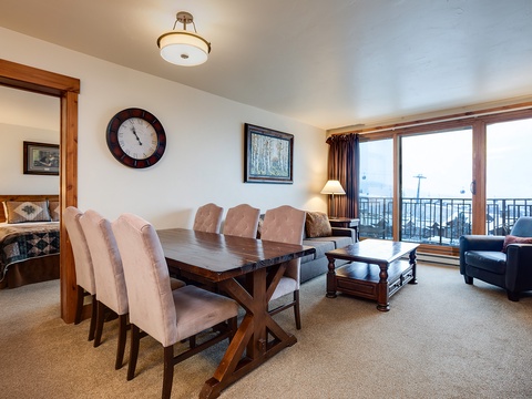 Picture yourself gathered around the handsome dining table, sharing meals and stories, then unwinding in the cozy living area with mountain views just beyond your balcony doors.