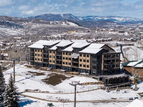 A winter retreat nestled in a snowy mountain valley, where majestic peaks frame your home away from home and crisp alpine air invites adventure just beyond the door.