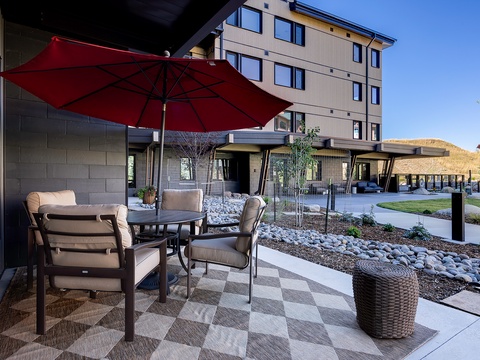 The property sits against a backdrop of rolling desert hills, offering a peaceful arrival experience. Landscaped courtyards and outdoor seating areas provide spaces to unwind and take in the surroundings.
