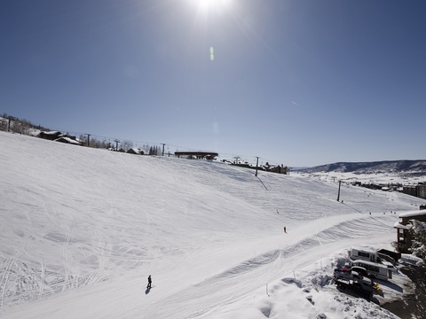 Pristine ski slopes stretch across snowy terrain near the property, offering access to winter sports and mountain recreation.
