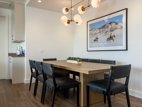 Gather around your spacious dining table under warm modern lighting, where shared meals become cherished memories. The open layout connects seamlessly to your kitchen for effortless entertaining.