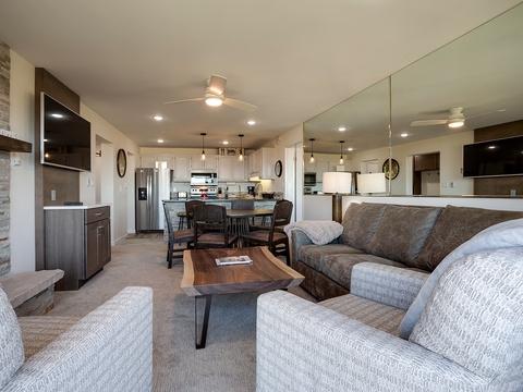 Your open-concept living space invites relaxation with plush seating, modern kitchen, and dining for memorable meals with loved ones.