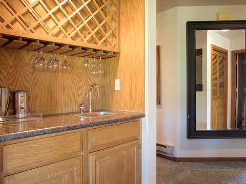 Your own wet bar awaits, complete with a built-in wine rack and sleek sink—perfect for pouring a glass and unwinding after a day exploring the area.