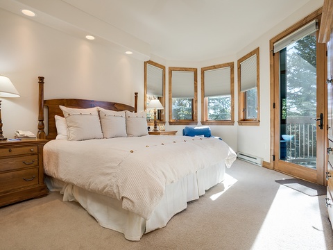 Sink into plush bedding and wake to mountain views through your private balcony door. Natural light fills your peaceful retreat with warm wood accents and everything you need to unwind.