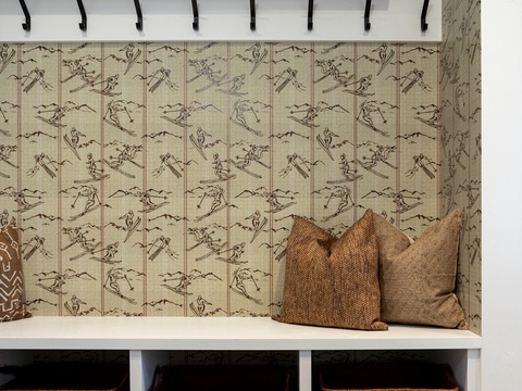 Store your gear and settle in. This organized entryway nook offers hooks, cubbies, and cozy seating with a charming ski-themed backdrop to welcome you home after every adventure.