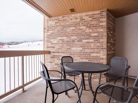 Your private balcony overlooks snowy ski slopes, offering a cozy spot to relax with morning coffee or unwind after a day on the mountain.