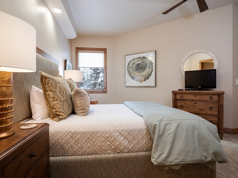 Sink into plush bedding and enjoy soft lighting in your serene bedroom retreat, complete with mountain views and modern comforts to ensure restful nights.