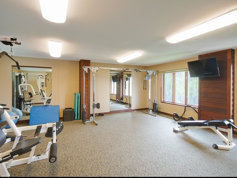 Stay active in your well-equipped fitness center, featuring cardio machines, strength training equipment, and a mounted TV to keep you motivated during your workout.