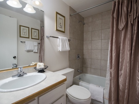 Step into your private bathroom with fresh towels and a relaxing tub-shower combo, ready for your comfort after a day of exploring.