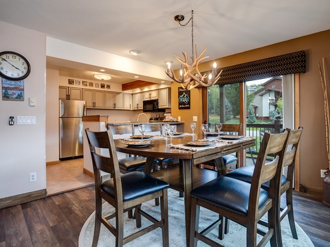 Gather with loved ones around the dining table, where rustic elegance meets modern comfort. The open kitchen invites effortless meal prep, while natural light and mountain-inspired décor create a warm, welcoming retreat for your stay.