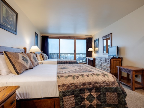 Sink into cozy beds with soft linens and wake to sweeping mountain views from your private balcony, perfectly framed by warm wood finishes throughout.
