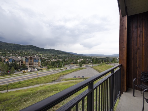 Mountain-view balcony overlooking a scenic valley and forested slopes—an ideal spot for morning coffee or evening relaxation after exploring the area.