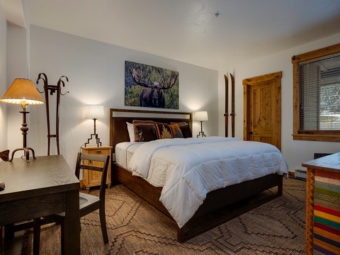 Your mountain retreat awaits with rustic wood furnishings, cozy bedding, and artwork celebrating the natural beauty of the wilderness around you.