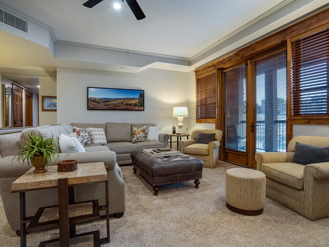 Settle into plush seating and unwind in your spacious living room, where natural wood accents and mountain views create a welcoming retreat after your day's adventures.