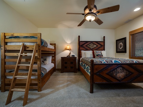 Your spacious bedroom features rustic wooden bunk beds and a beautifully carved twin bed, perfect for families or groups seeking comfort with Southwestern charm.
