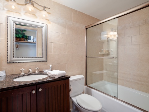 Step into your spotless bathroom with soft lighting, elegant tile, and a refreshing tub-shower combo—everything you need to unwind after a day of exploring.