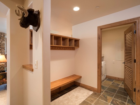 Rustic entry with custom bench seating and storage—ideal for stowing your gear after mountain adventures. The welcoming lodge atmosphere starts the moment you arrive.