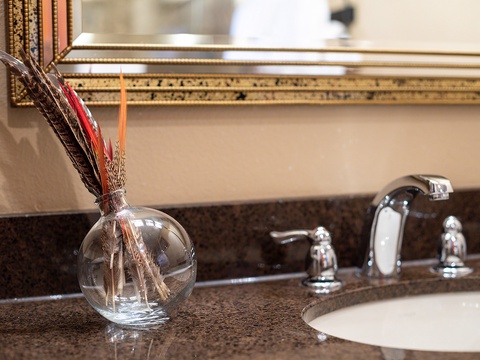 Your bathroom features polished granite countertops, elegant gold-framed mirrors, and modern fixtures—a refined space where you'll refresh after each adventure.