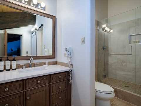 Your private bathroom features a spacious walk-in shower, elegant vanity with premium amenities, and modern fixtures to help you unwind and refresh.
