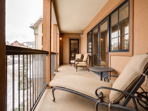 Your private covered balcony invites you to relax in cushioned seating while taking in peaceful mountain views and fresh alpine air.