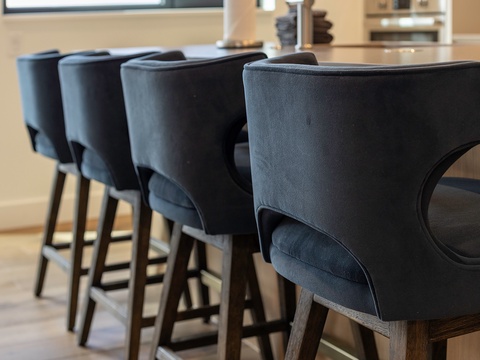 Gather around your stylish kitchen island with plush velvet counter seating, perfect for morning coffee or evening conversations with friends.