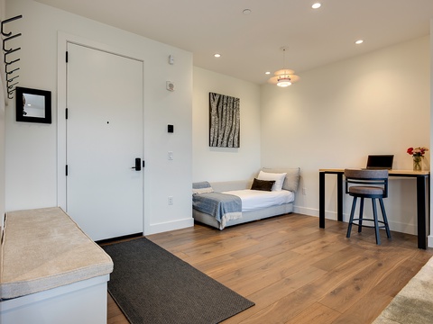 Step into your bright, thoughtfully designed space where modern comfort meets minimalist elegance. Warm wood floors guide you through open living areas with clean lines and natural light.